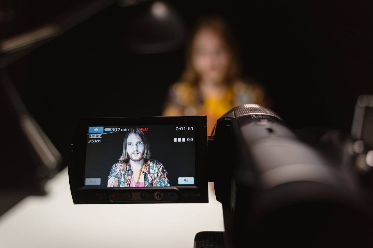 Close-up view of camera capturing a persons portrait in a recording studio.